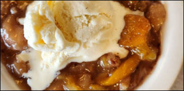 Peach Cobbler with Vanilla Ice Cream at His Place Eatery