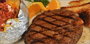 Rib Eye Steak with loaded Baked Potato at T-Bone Tom's Steakhouse